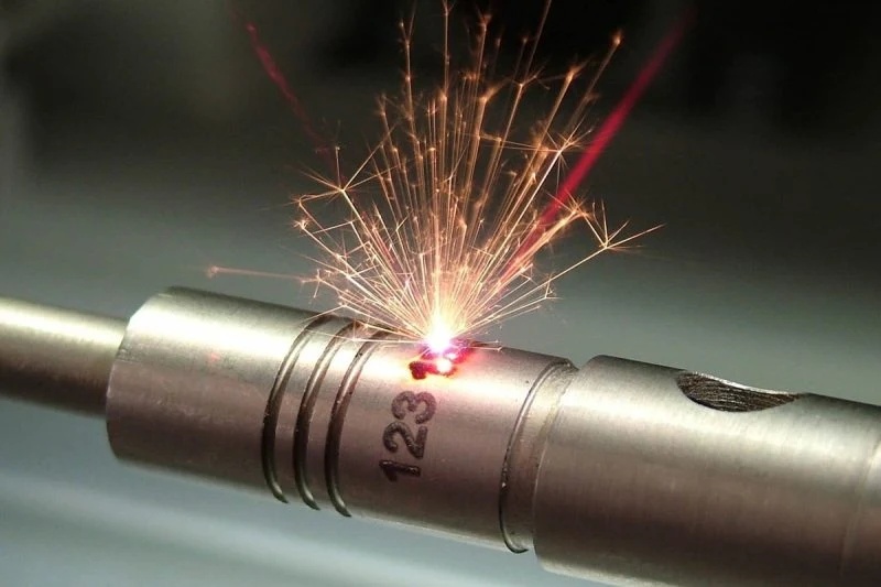 Laser marking an identification number on a metal component